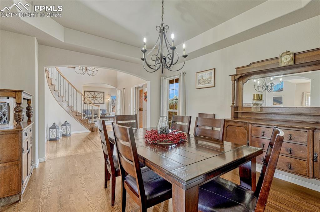 Image 6 of 48: Formal dining with hardwood floors...