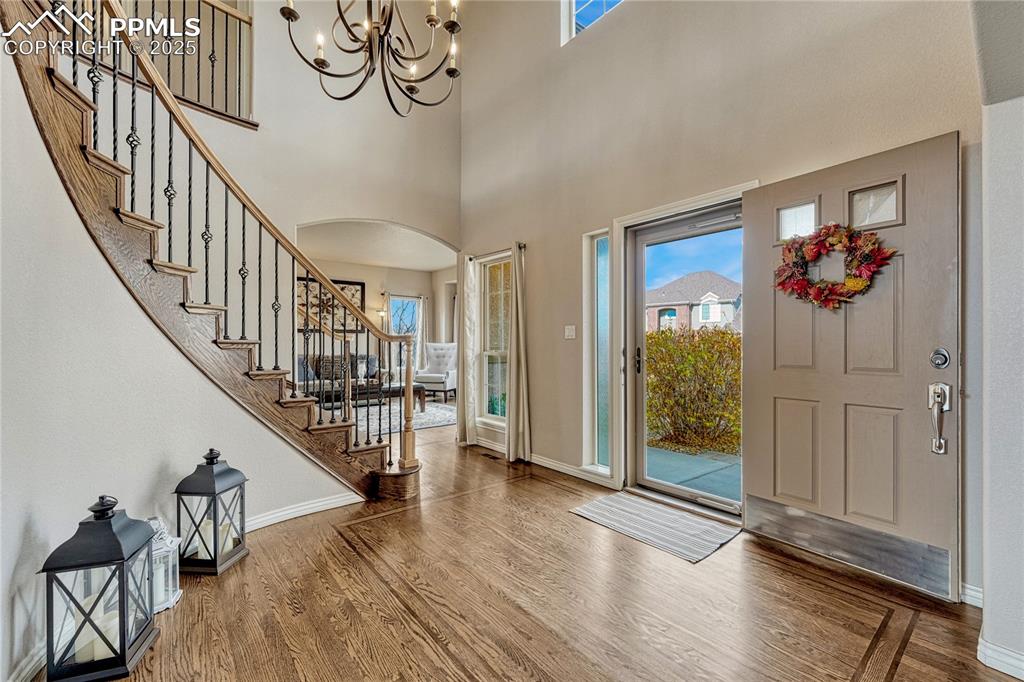 Image 8 of 48: Covered entry to hardwood floors with inlay. 