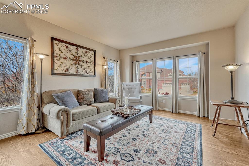 Image 9 of 48: Formal living room with several windows...