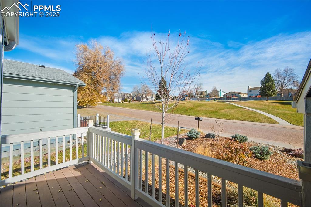 Image 28 of 50: Wooden terrace featuring a residential view and a yard