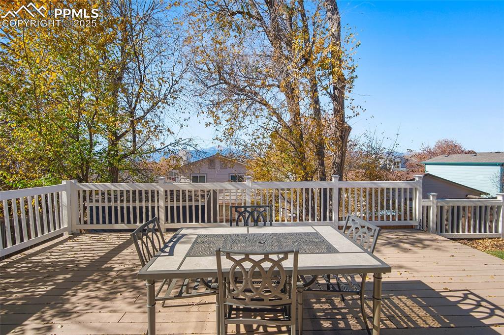 Image 36 of 50: Wooden terrace with outdoor dining space