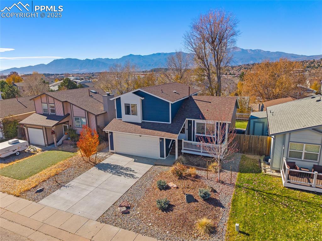 Image 37 of 50: View of front facade featuring a residential view, driveway, a deck with mo