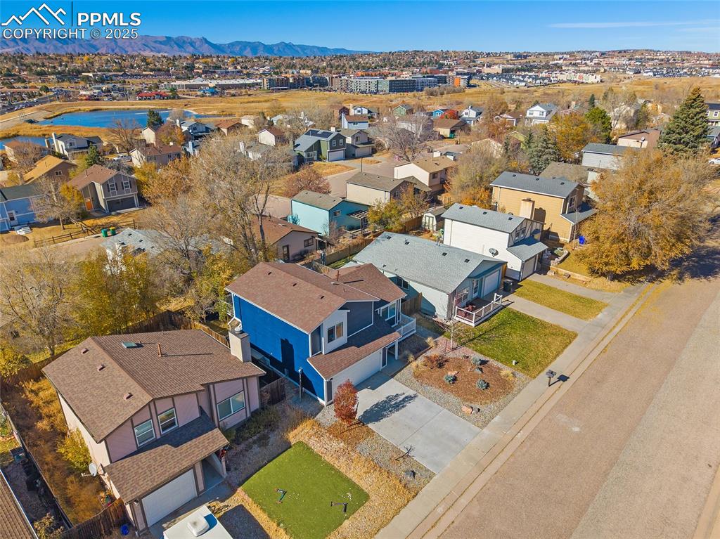 Image 40 of 50: Aerial perspective of suburban area with mountains