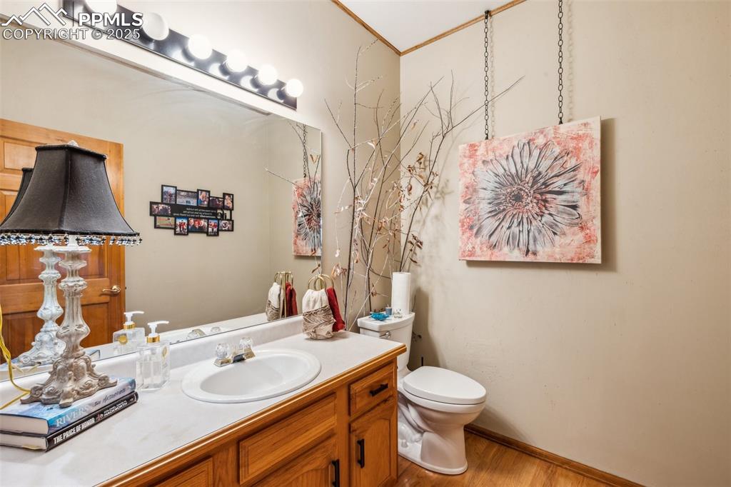 Image 19 of 43: Bathroom featuring wood finished floors and vanity