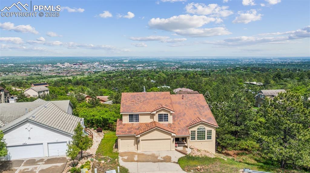 Image 2 of 43: Aerial view of property and surrounding area with a heavily wooded area