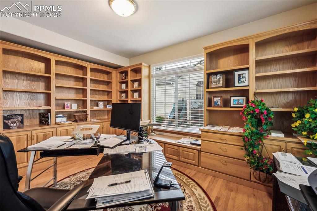 Image 21 of 43: Home office featuring light wood finished floors