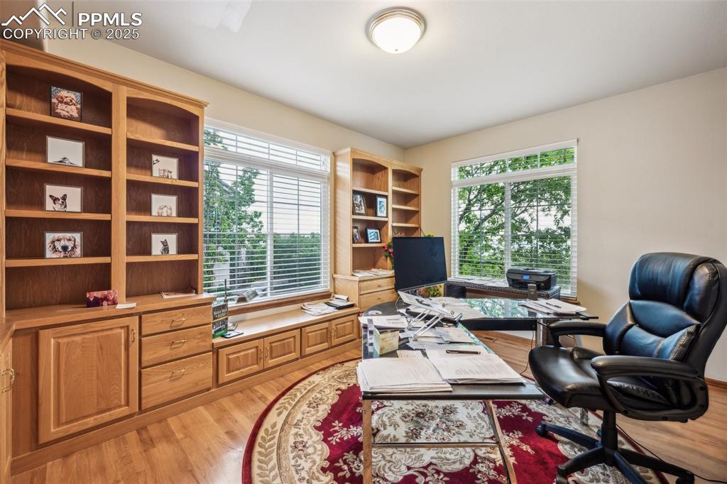 Image 22 of 43: Office area featuring healthy amount of natural light and light wood-type f