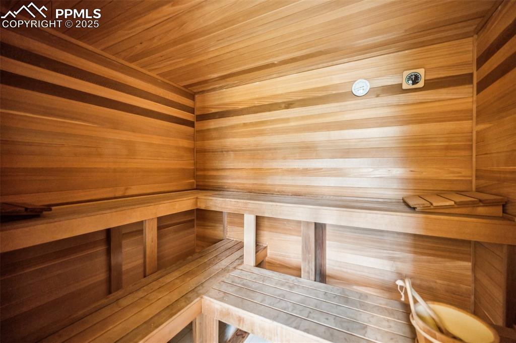 Image 38 of 43: Relaxing sauna featuring wooden ceiling and wood walls