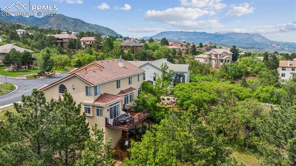 Image 5 of 43: Aerial view of residential area featuring a mountainous background