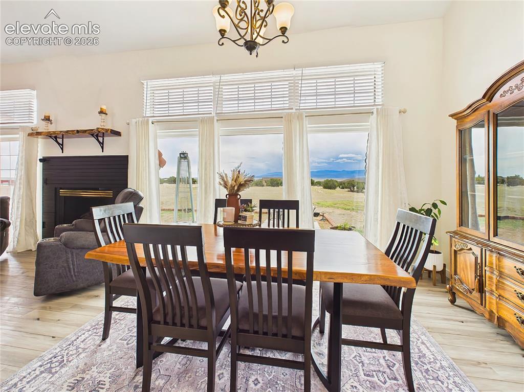 Image 13 of 50: Spacious dining area is surrounded by oversized windows that fill the space