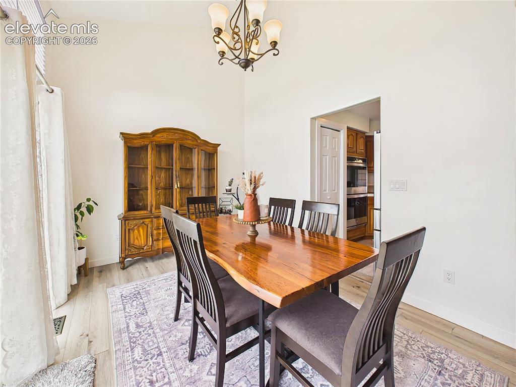 Image 14 of 50: Vaulted ceilings and updated flooring create an airy atmosphere, while the