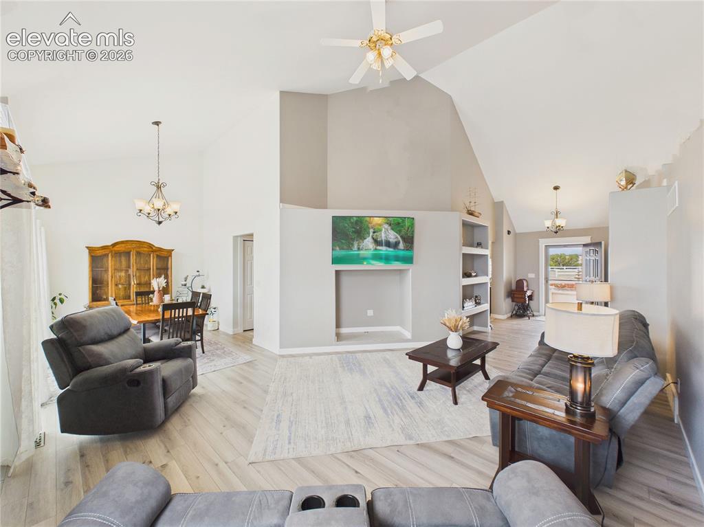 Image 18 of 50: Open-concept great room showcases soaring ceilings, expansive sightlines, a