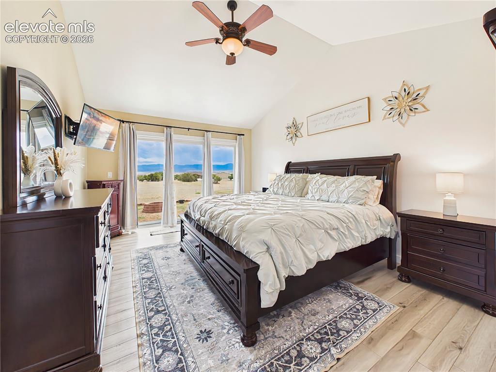 Image 22 of 50: Large picture windows frame beautiful mountain and prairie views while fill