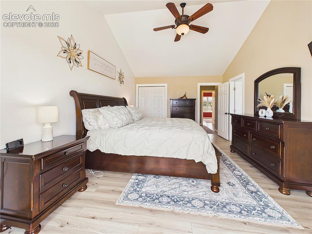 Image 23 of 50: Spacious primary suite features vaulted ceilings, updated flooring, and a c