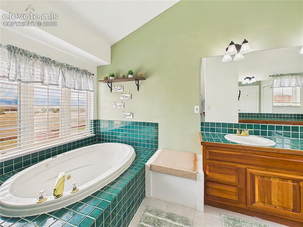 Image 26 of 50: Bright and inviting retreat featuring custom tilework, abundant natural lig