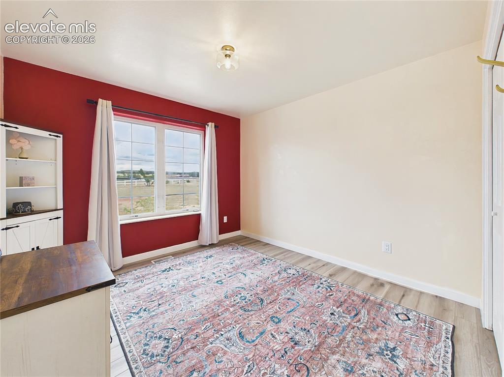 Image 30 of 50: Bedroom 3 with large window fills the room with natural light while offerin