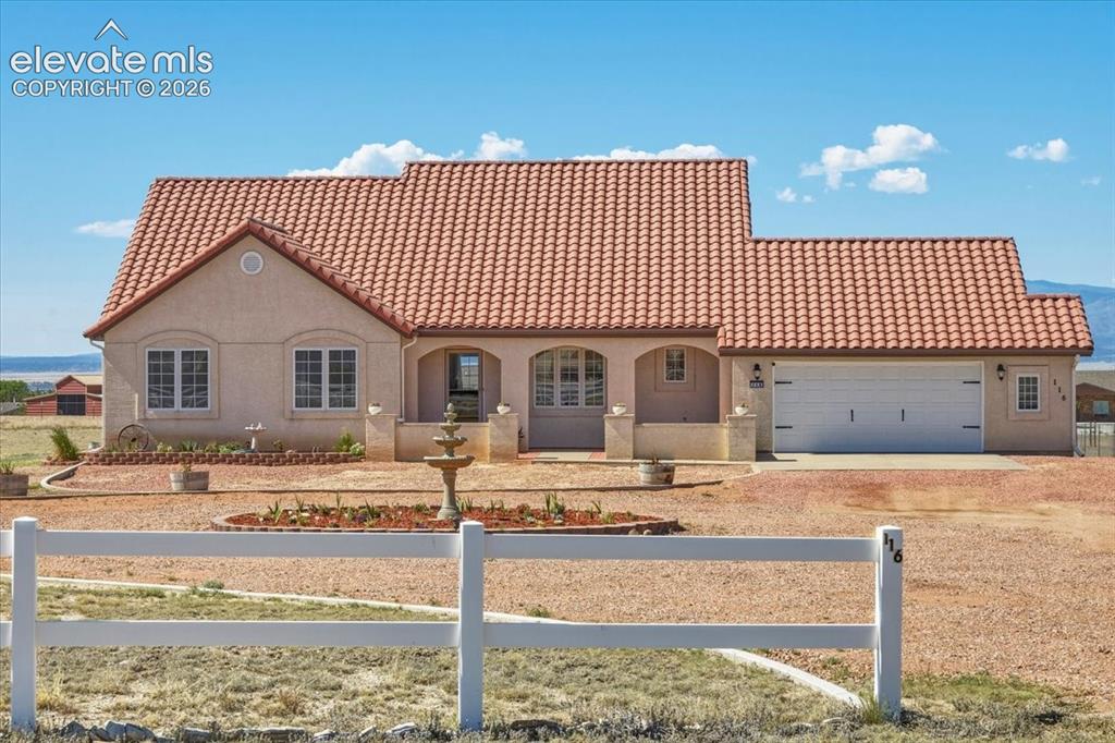 Image 39 of 50: Welcoming covered entry with arched architectural details and a spacious fr