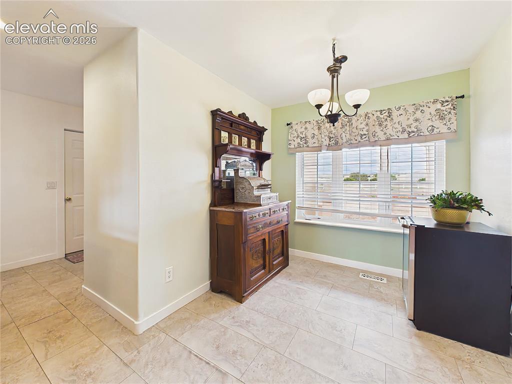 Image 6 of 50: Bright breakfast area is positioned beside large windows, creating a cheerf