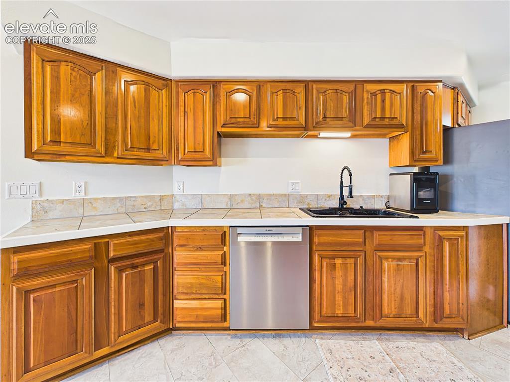 Image 7 of 50: Rich wood cabinetry and extensive countertop space provide ample storage an