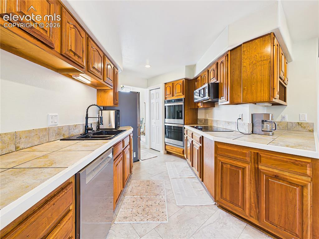 Image 9 of 50: Thoughtfully designed galley-style layout offers excellent workflow, with a