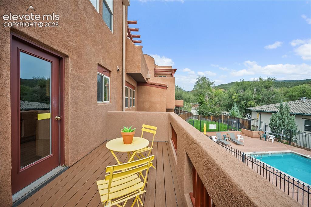Image 10 of 40: Balcony over looks the pool. 