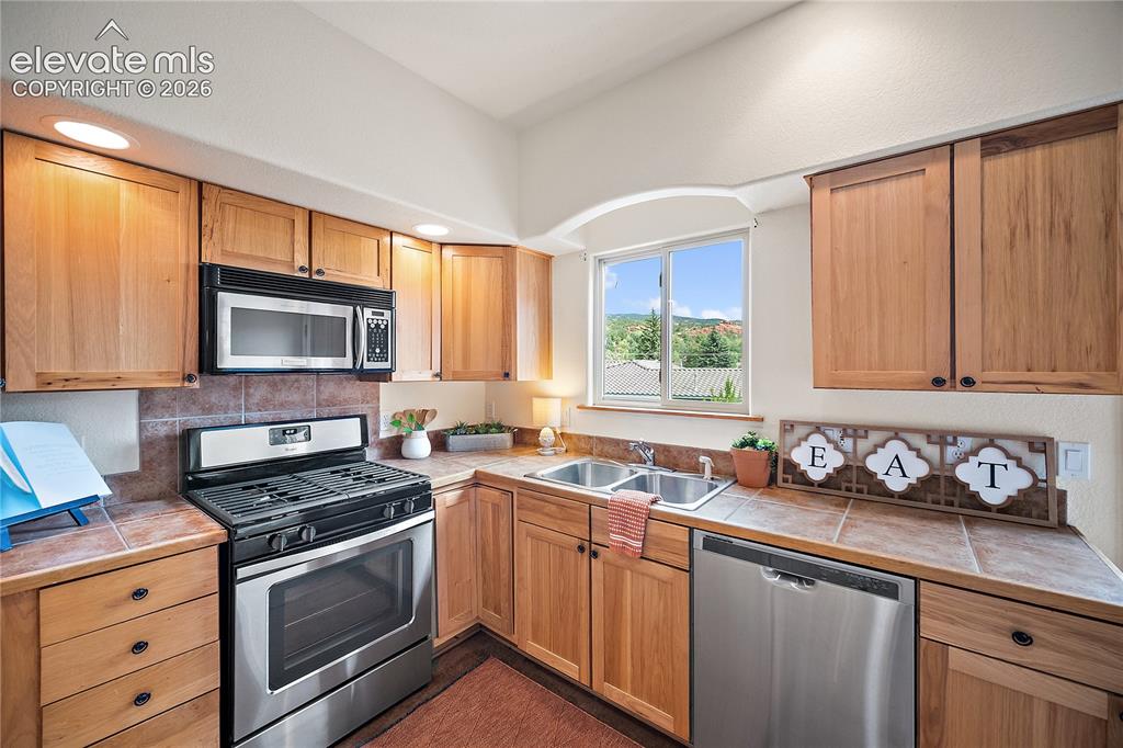Image 12 of 40: Gas range, plenty of cabinet and counter space.