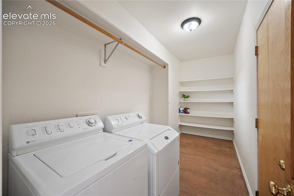 Image 15 of 40: Main level laundry with additional storage space.