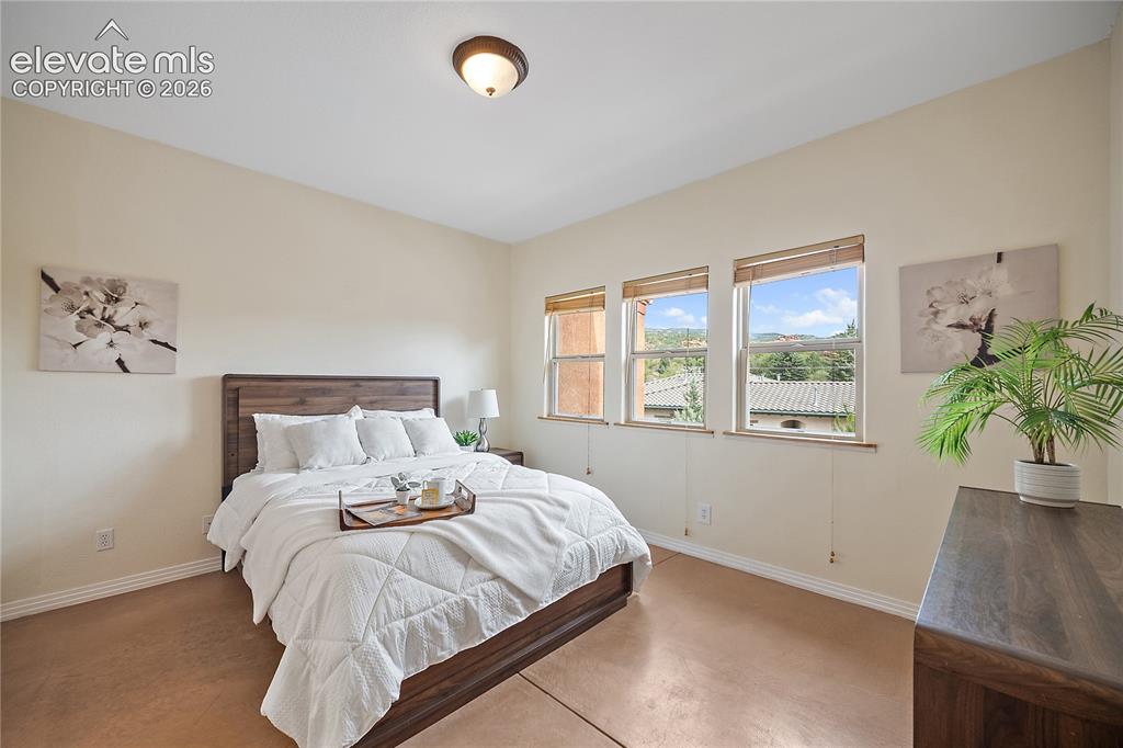 Image 16 of 40: Main level primary suite that is open an bright. 