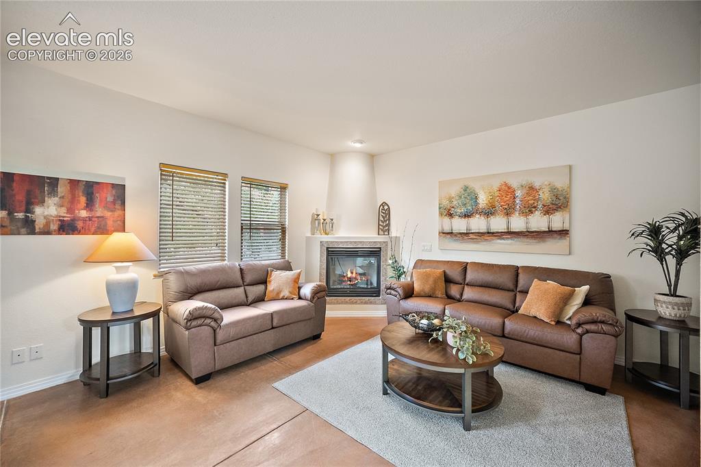 Image 5 of 40: Corner gas fireplace and large windows for natural light.