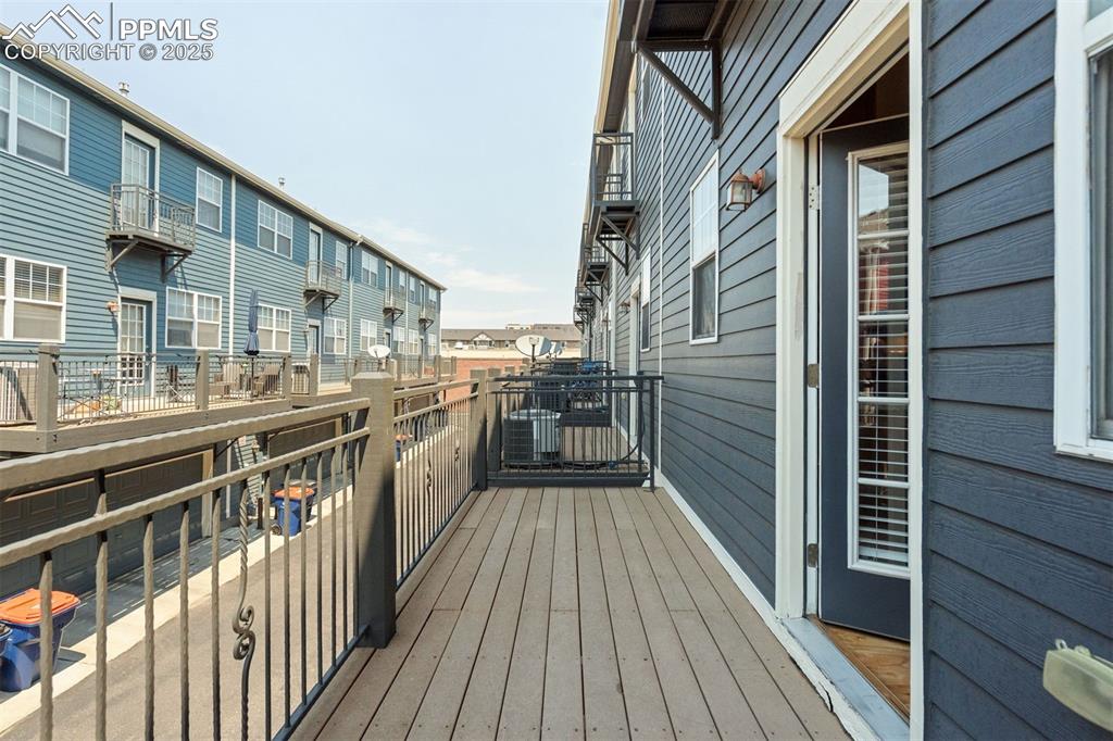 Image 24 of 43: Balcony off of the eat-in kitchen is low-maintenance composite decking.