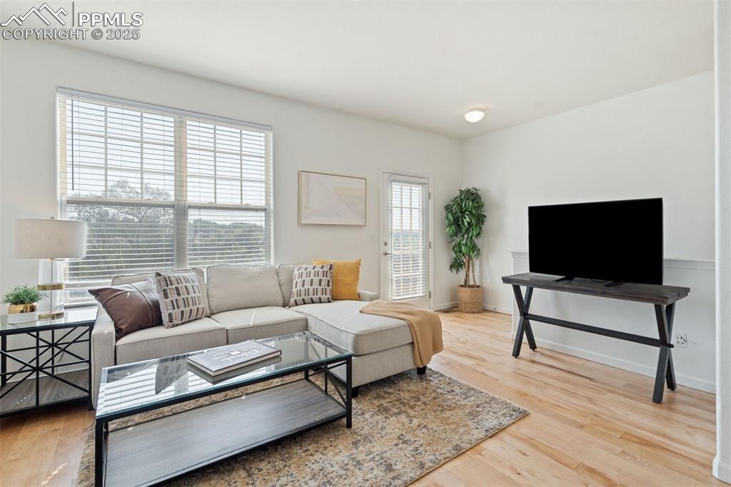 Image 4 of 43: This living space is filled with natural abundant light in this open-concep