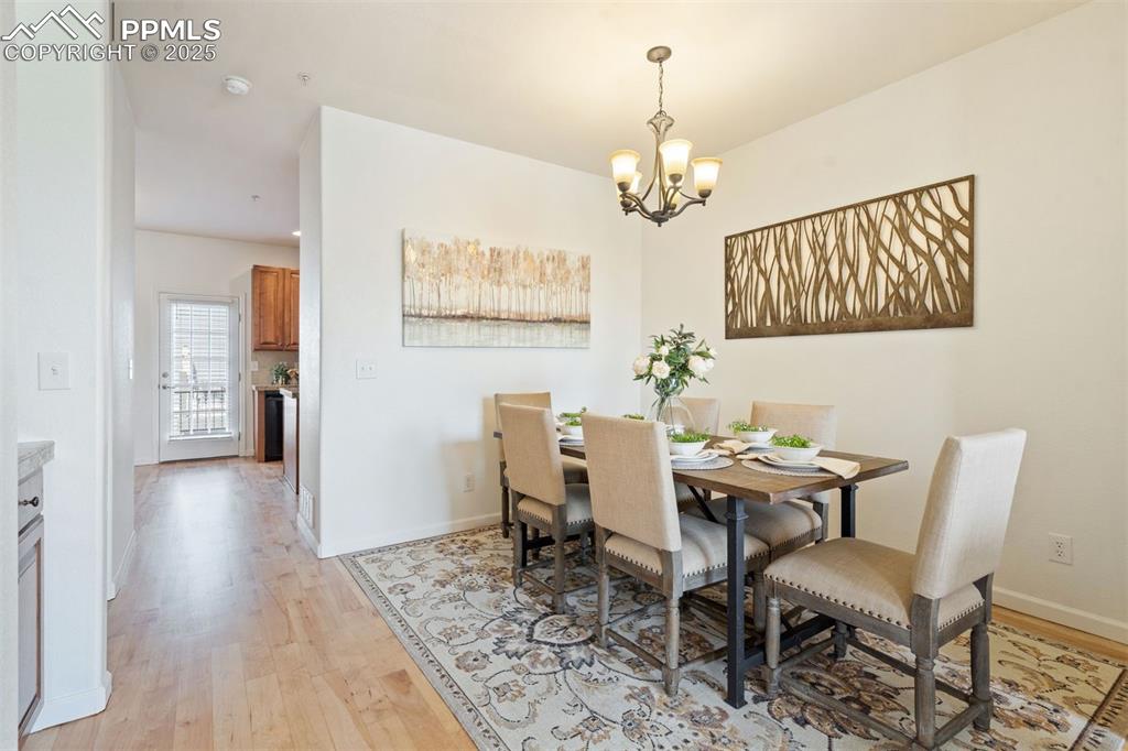 Image 6 of 43: Sophisticated dining space anchored by natural light and graceful flow from