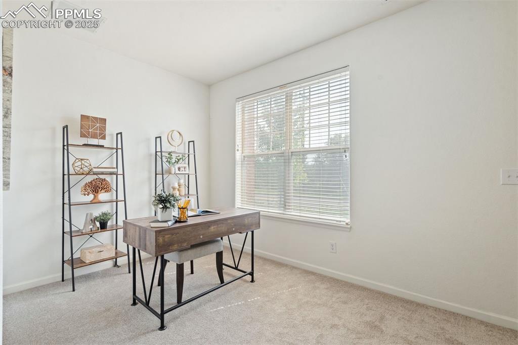 Image 8 of 43: Upon entry, a sunlit flex space provides the perfect setting for a home off