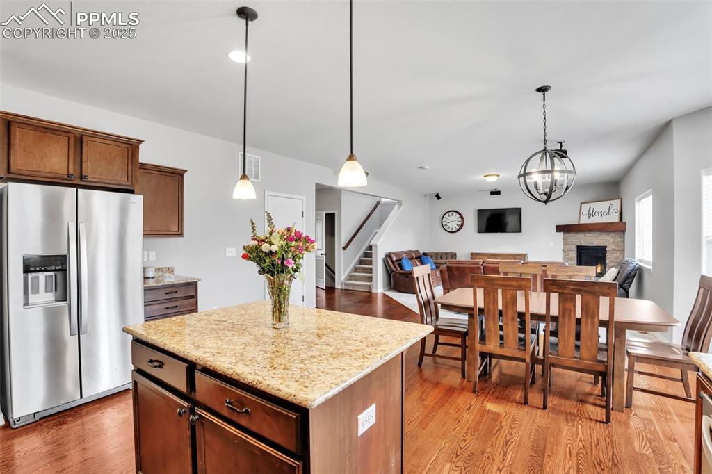 Image 13 of 50: Kitchen with light wood-type flooring, open floor plan, stainless steel ref