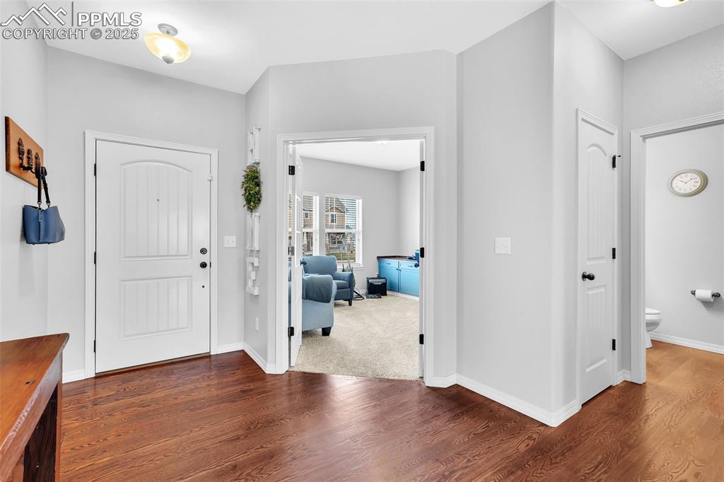 Image 2 of 50: Foyer featuring baseboards and wood finished floors
