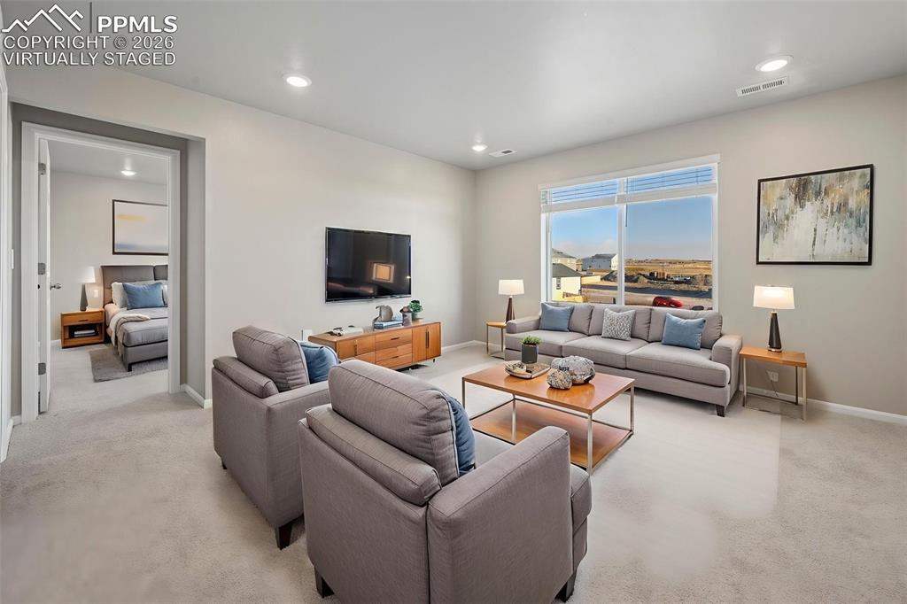 Image 13 of 39: Virtually staged oversized loft at top of the stairs, serves as family room