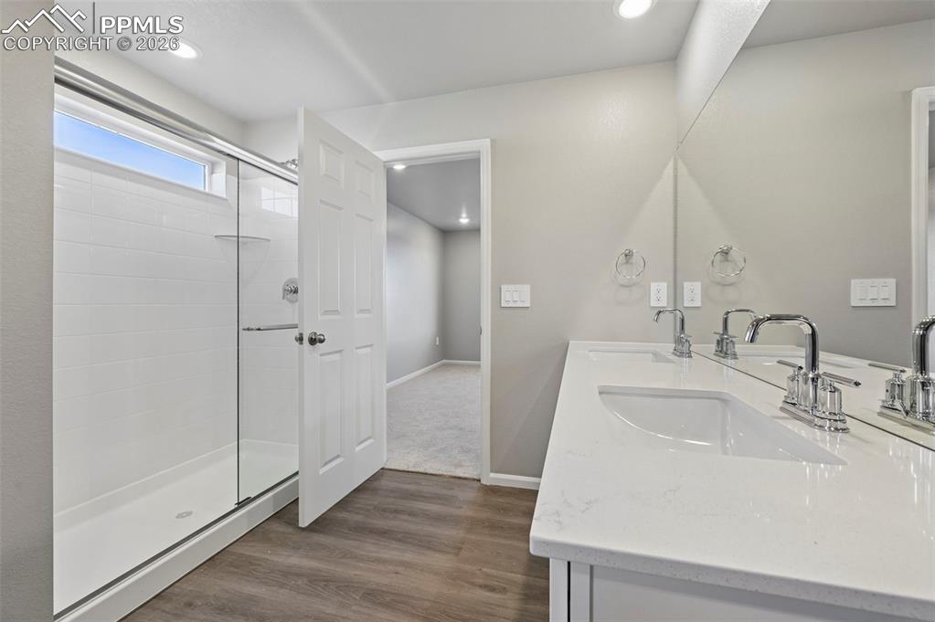 Image 21 of 39: Primary bathroom with standing shower, dual vanity and oversized walk in cl