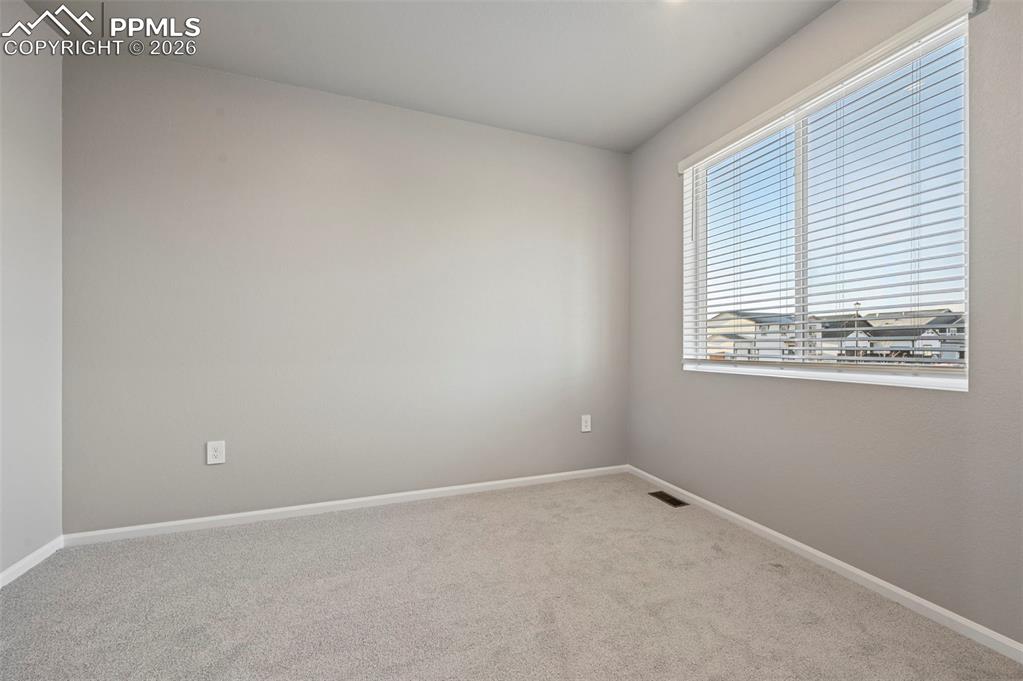 Image 4 of 39: Unstaged flex room serves as dedicated office, formal dining room, or addit