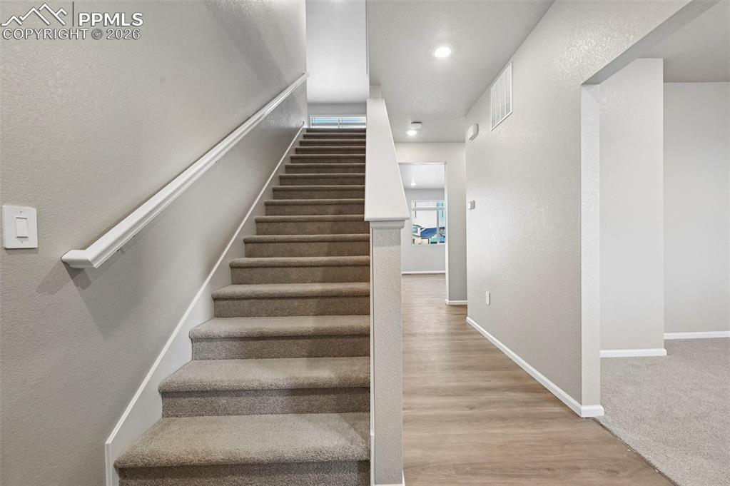 Image 5 of 39: Entry, looking into adjacent office and down hall to main floor living