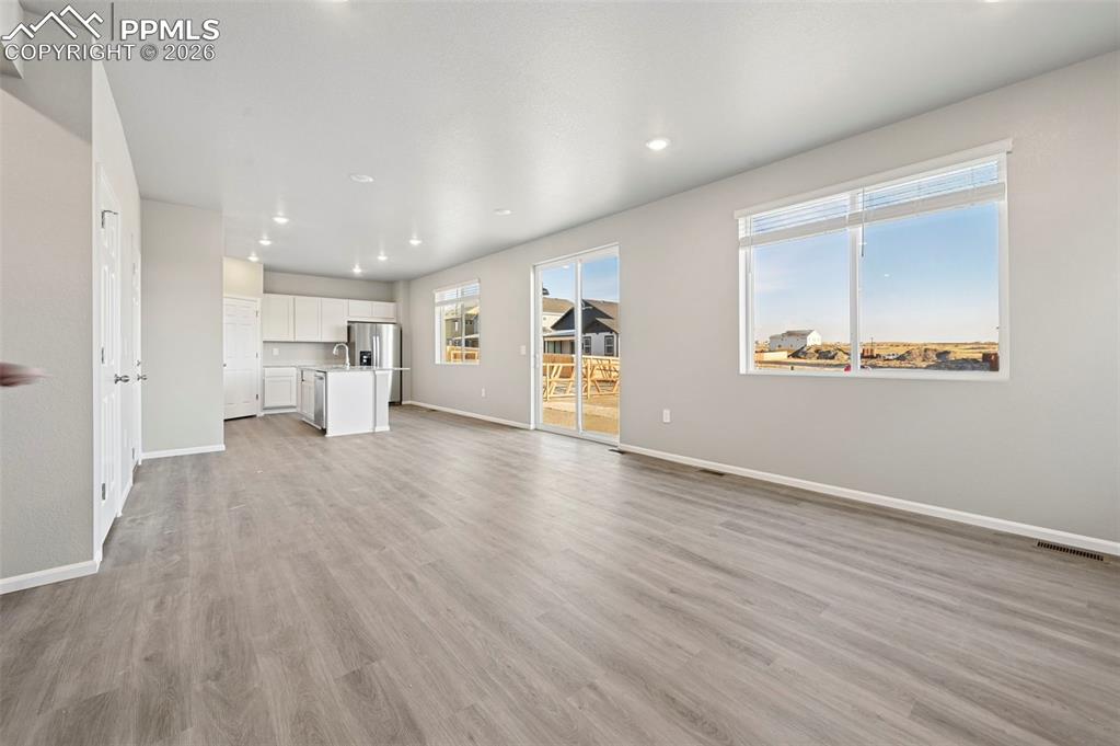 Image 7 of 39: Unstaged living room, large open concept 