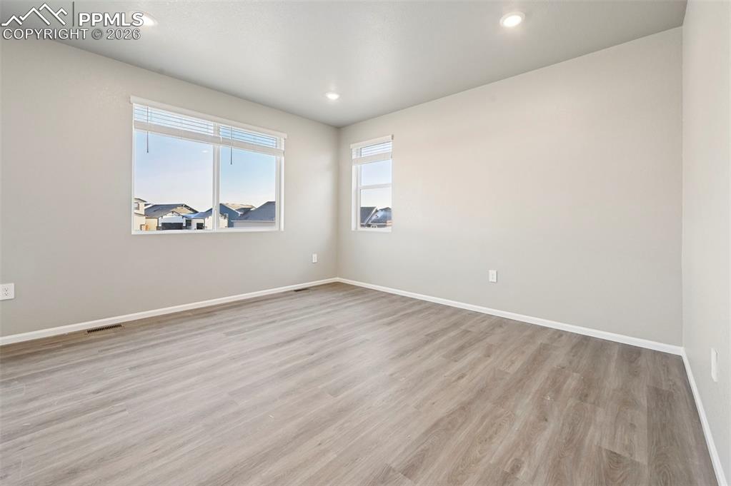 Image 8 of 39: Unstaged living room with beautiful LVP flooring 