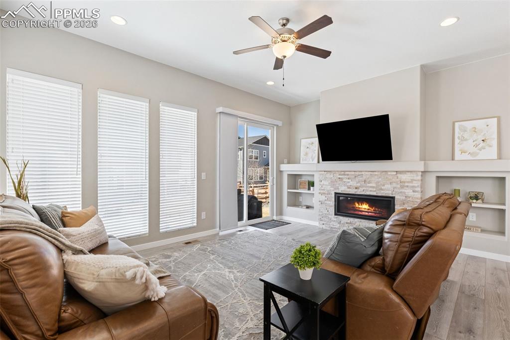 Image 11 of 46: Fireplace flanked w/ custom built-ins