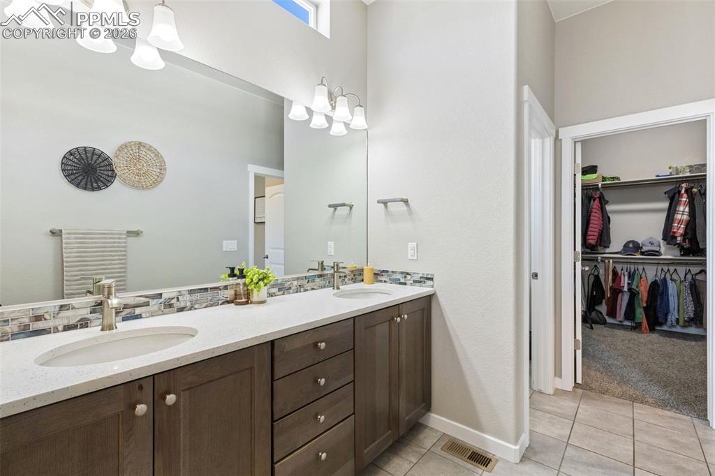 Image 18 of 46: Primary bath facing walk-in closet & water closet toilet