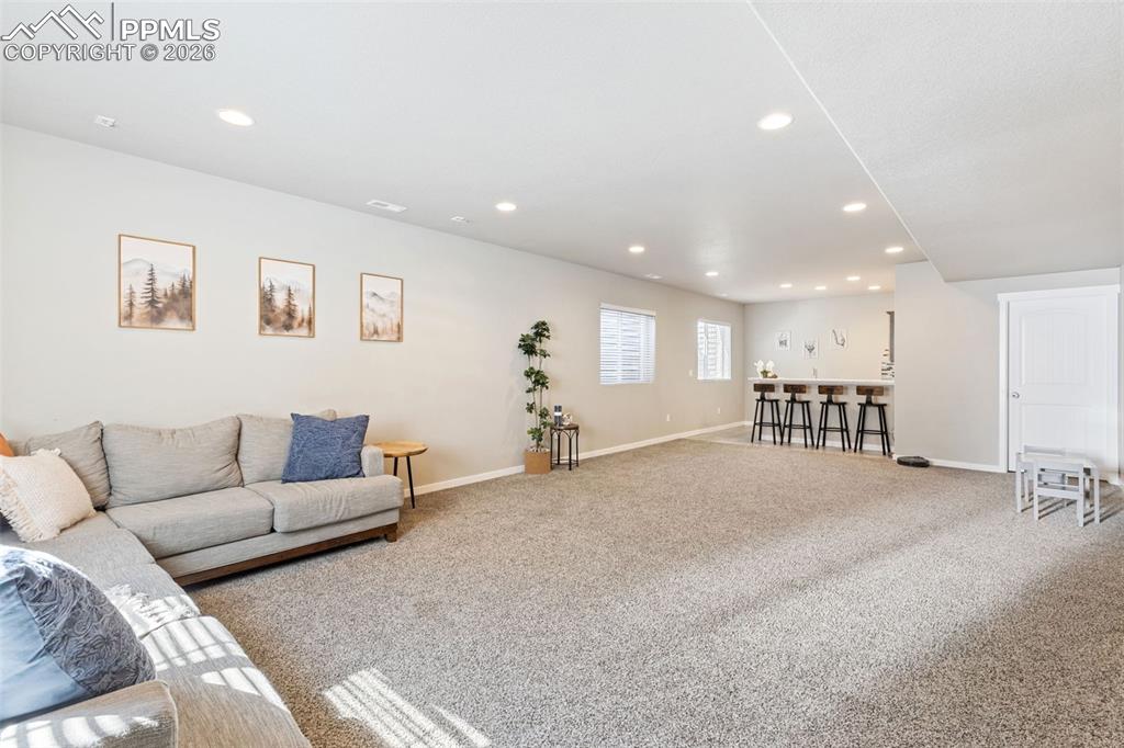 Image 23 of 46: Huge basement area w/ wet bar and storage at the other end