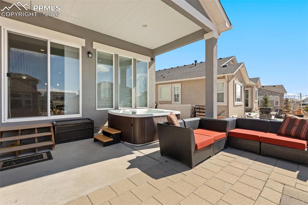 Image 31 of 46: Backyard patio with hot tub