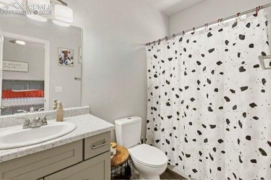 Image 17 of 23: Full bath with ensuite bathroom, vanity, and a shower with curtain