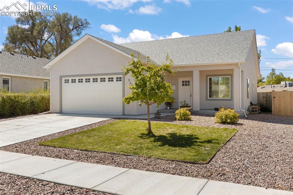 Image 2 of 23: Ranch-style house with driveway, an attached garage, roof with shingles, an