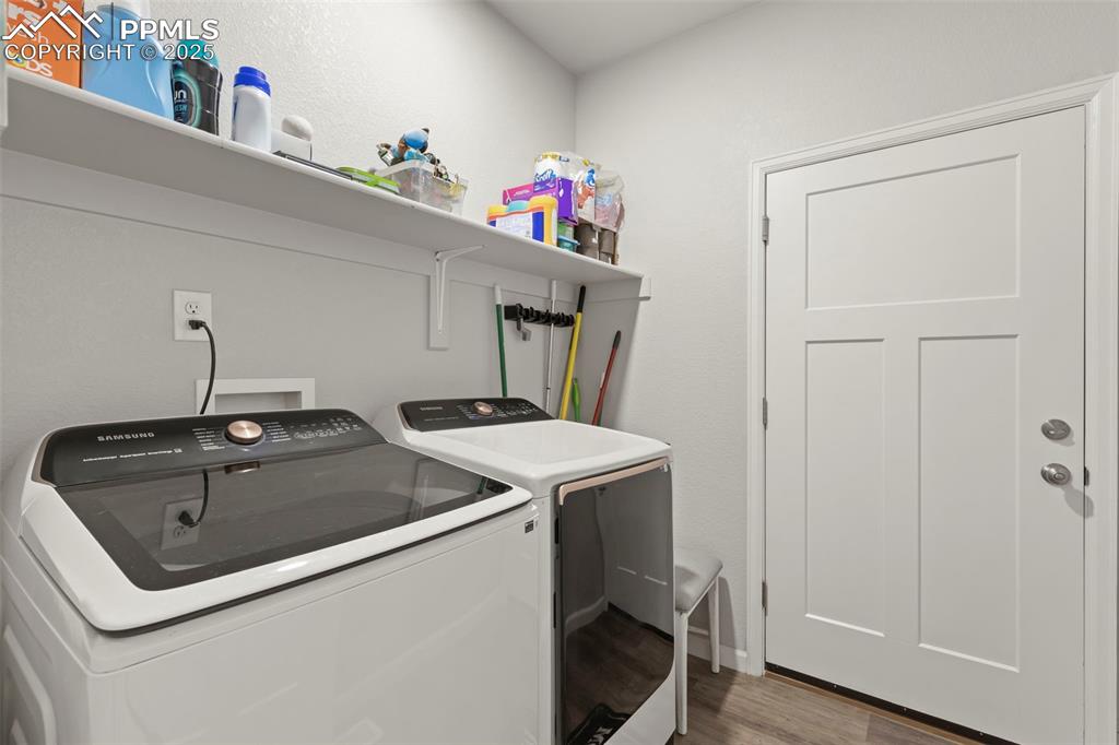 Image 23 of 23: Laundry room with light wood-type flooring and independent washer and dryer