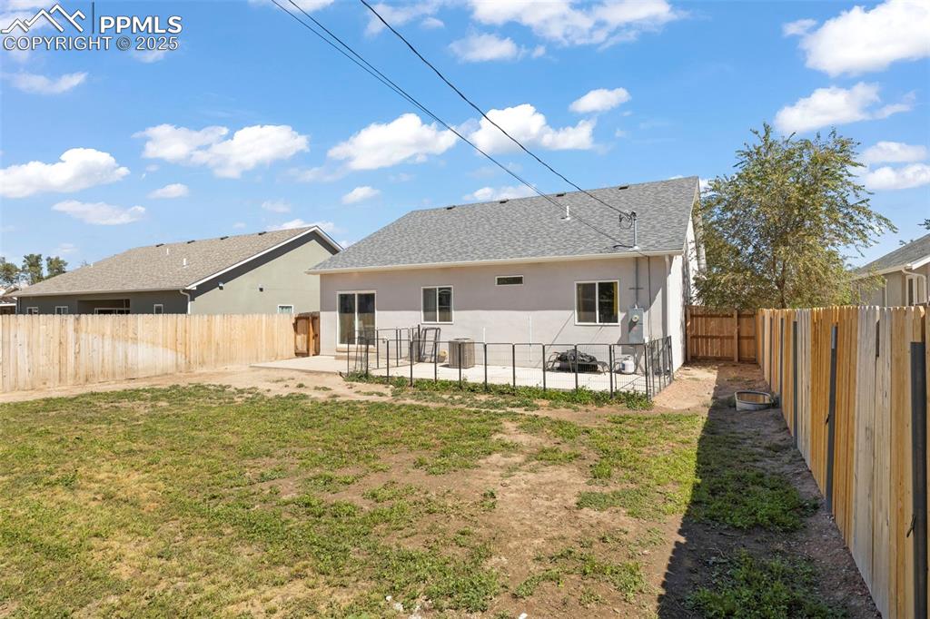 Image 5 of 23: Back of property with a patio, a fenced backyard, stucco siding, and a shin