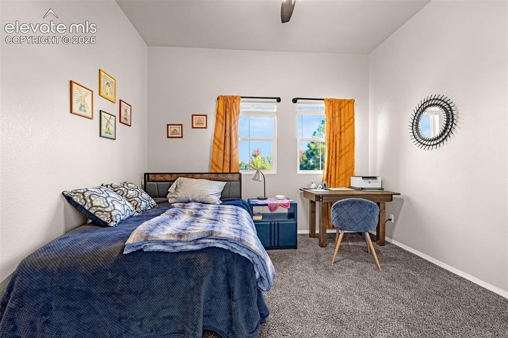 Image 14 of 27: Neutral interior space featuring high ceilings, two double-hung windows, an